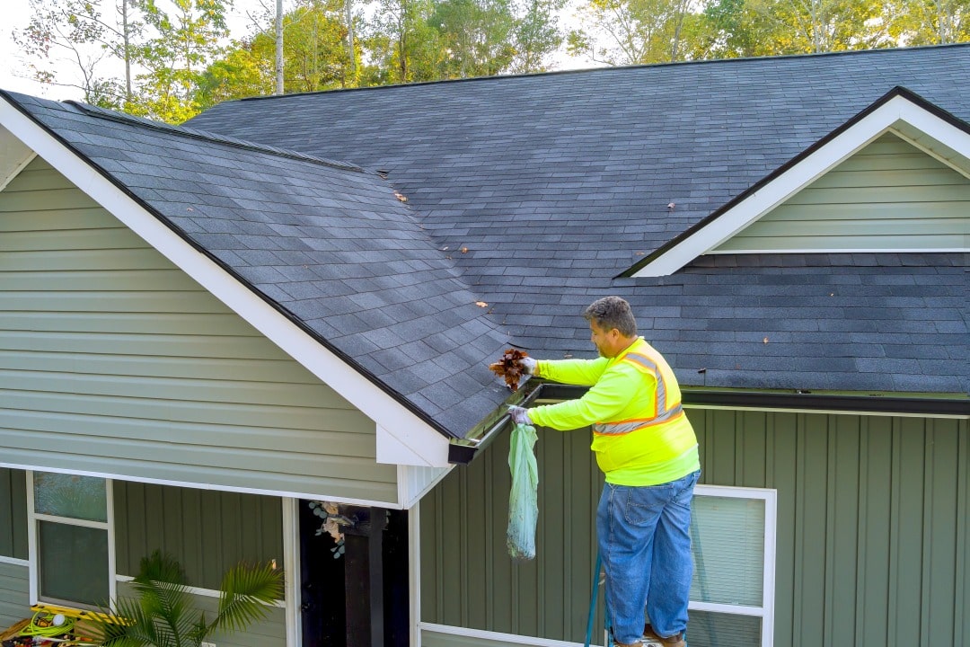 Spring gutter cleaning during exterior home inspection