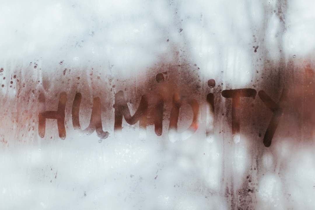 Foggy glass with the word 'humidity' written in condensation