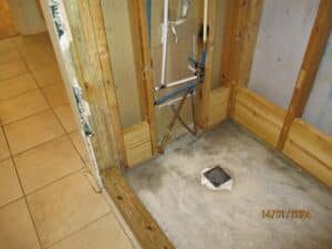 Exposed interior wall with plumbing during mold remediation