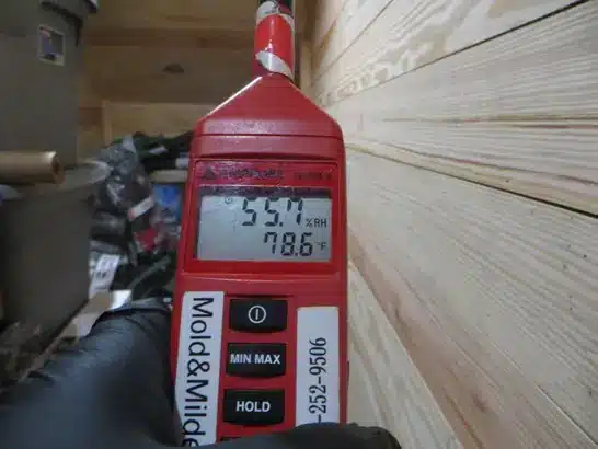 Checking temperature and humidity in a basement with a hygrometer
